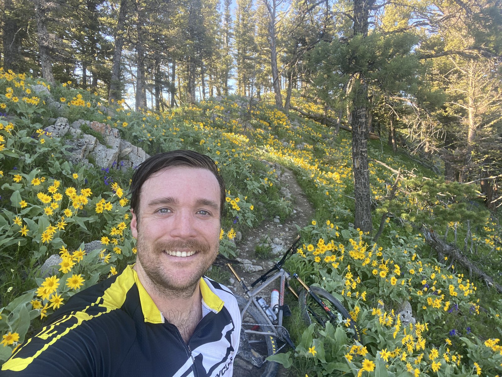 Jordan Schupbach on a wildflower-lined mountain bike trail near Bozeman, MT.